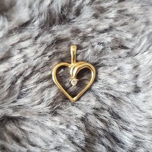 22k gold pendant with a tiny diamond